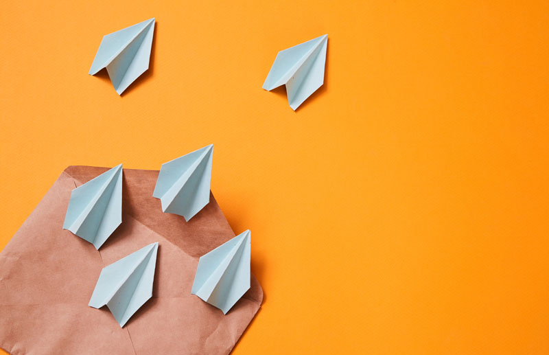 Small group of paper airplanes moving out of a envelope