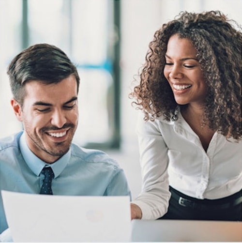 Female and Male talking looking at a piece of paper