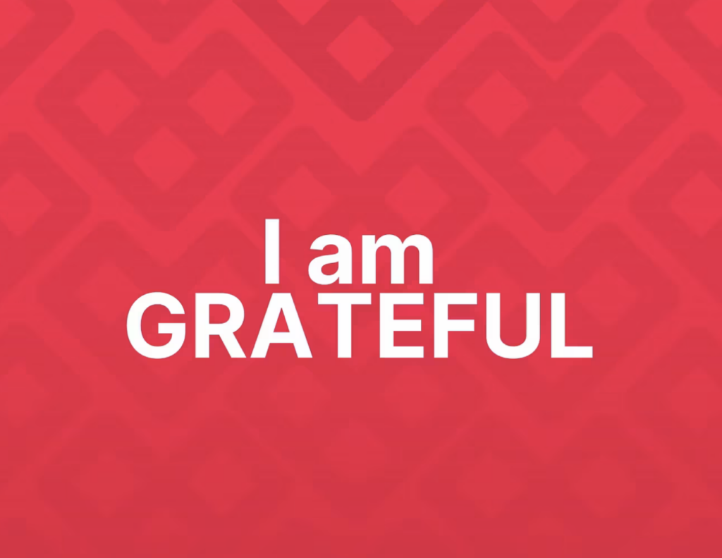 Red background with white letters that says I am Grateful